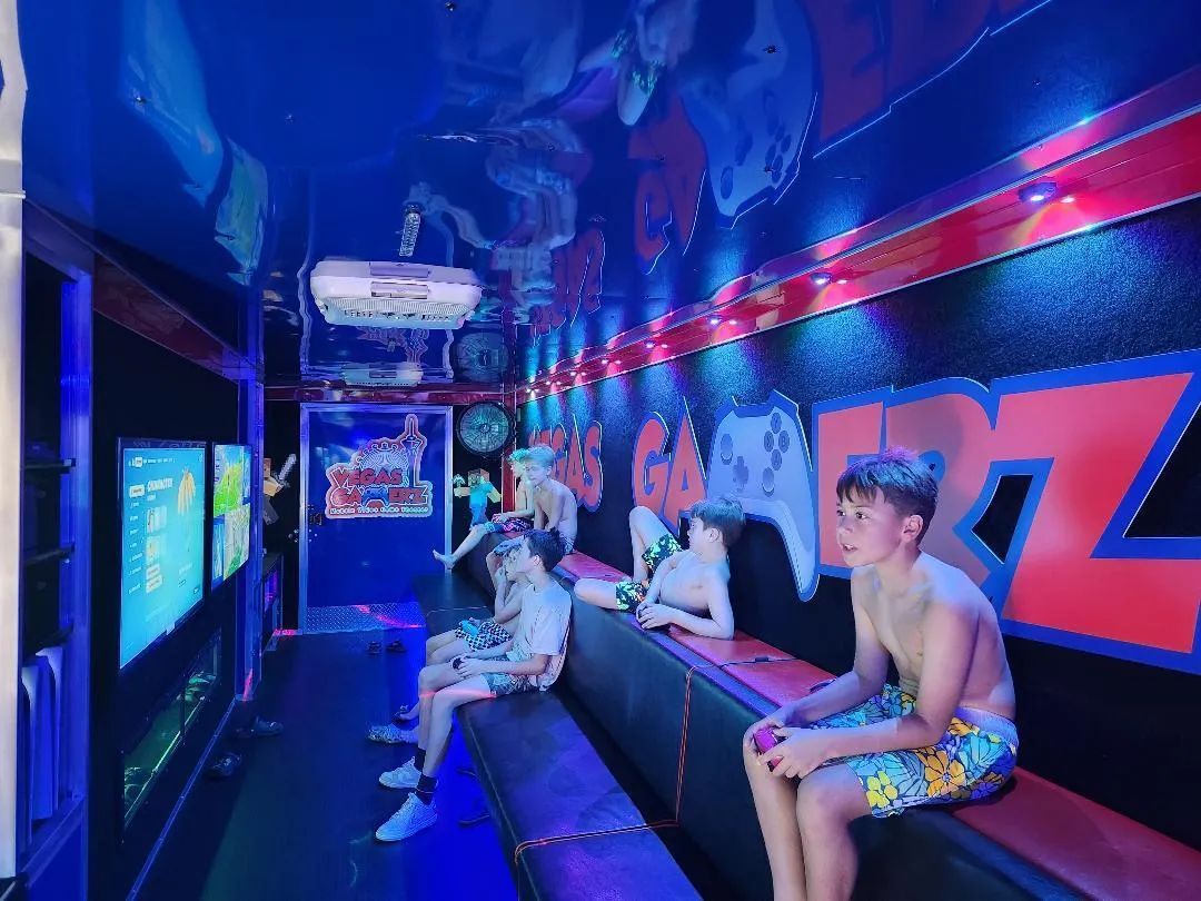 Boys playing on the bench inside the trailer under LED strip lighting
