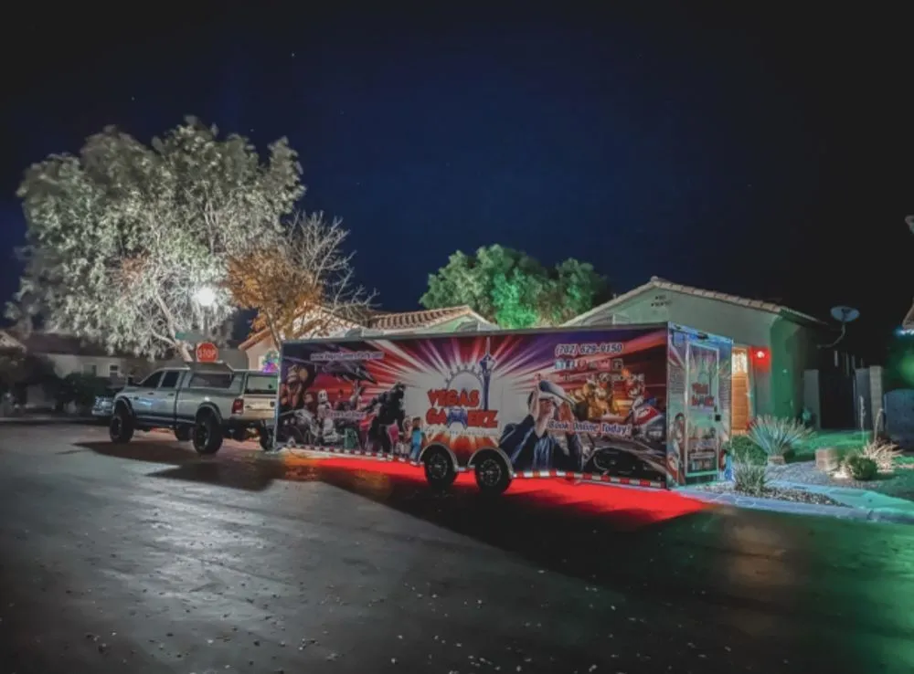 The Vegas Gamerz trailer lit red at a residential Las Vegas curb at night